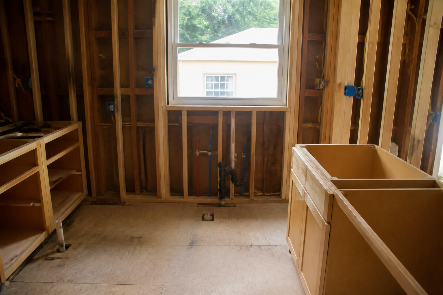 Kitchen remodel plumbing rough-in with supply lines and drain stub-out before cabinets are installed